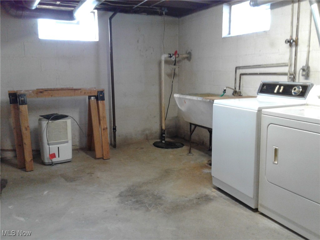 332 Claremont Road Vermilion, OH 44089 - Photo 28 of 35 Basement featuring washing machine and clothes dryer, plenty of natural light, and a Utility Tub