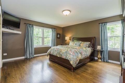 737 West Bauer Road Naperville, IL 60563 - Photo 12 of 25 a bed sitting in a spacious bedroom next to a window and a flat screen tv
