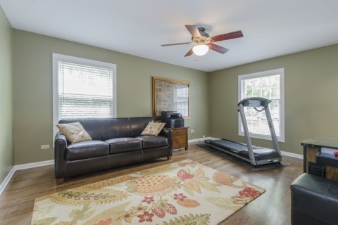 737 West Bauer Road Naperville, IL 60563 - Photo 15 of 25 a living room with furniture gym equipment and a window