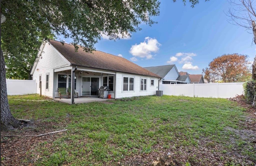 10665 Huntridge Road Orlando, FL 32825 - Photo 3 of 12 a view of a house with a yard and porch