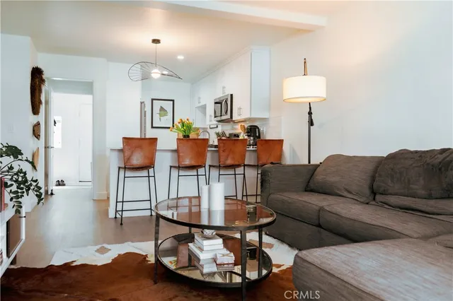 a kitchen with stainless steel appliances granite countertop a sink a stove and a wooden floor