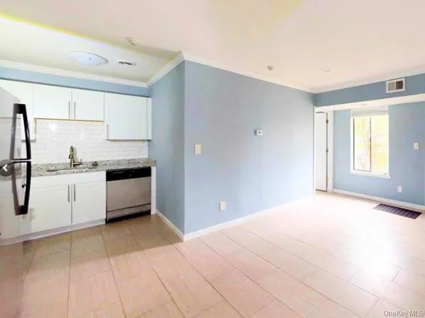 a kitchen with stainless steel appliances a refrigerator sink and cabinets