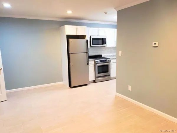 a kitchen with a refrigerator and a stove