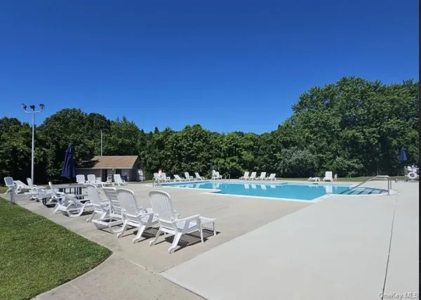a view of a backyard with sitting area