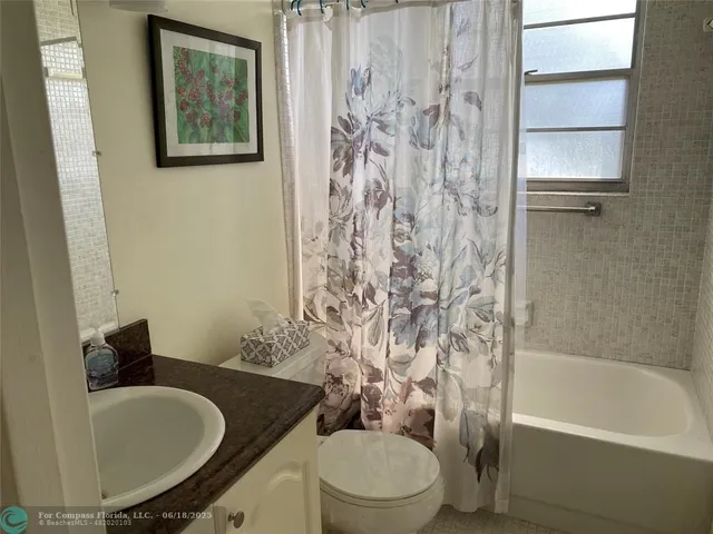 a view of a livingroom with furniture and a flat screen tv