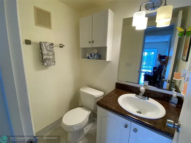 an outdoor view of a house with a garden and parking space