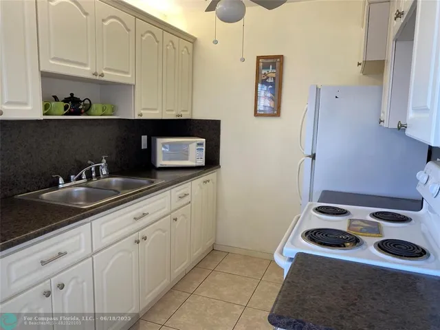 a kitchen with sink cabinets and stove