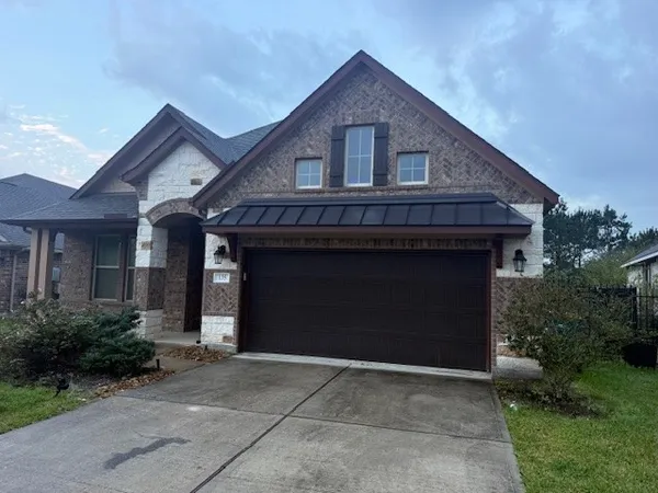 a front view of a house with yard and parking