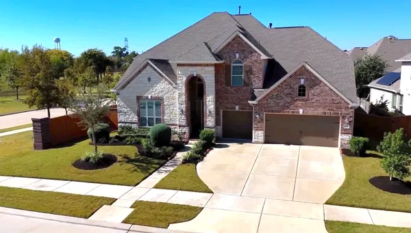 a view of a house with swimming pool and sitting area