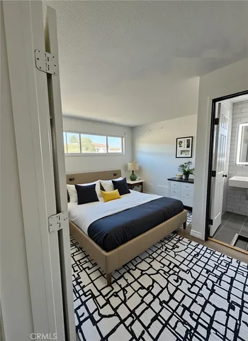 a bedroom with a bed and a dresser