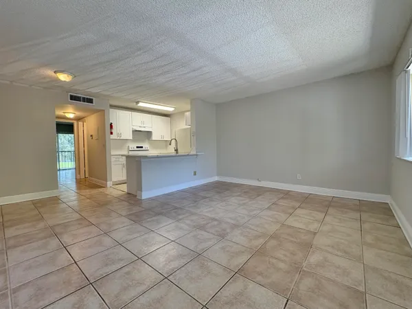 a view of a kitchen with a sink and a refrigerator