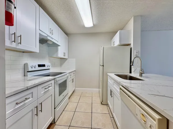 a kitchen with stainless steel appliances granite countertop a sink and cabinets