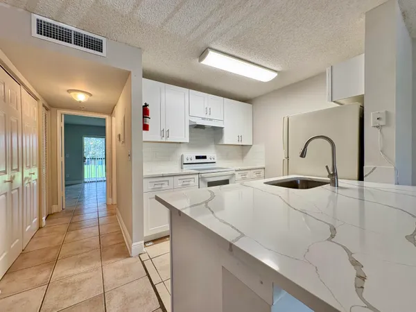 a kitchen with a sink cabinets and appliances