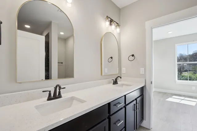 a bathroom with a sink double vanity and a mirror