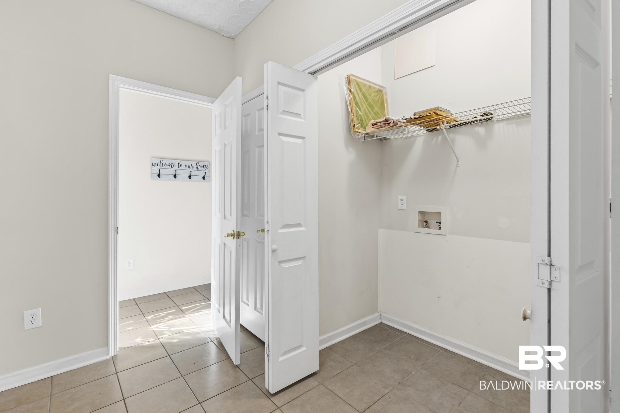 1153 Sloane Cove Foley, AL 36535 - Photo 12 of 25 Laundry area with washer hookup and light tile patterned floors