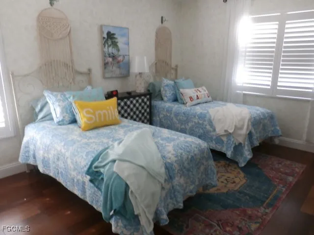 a bedroom with two beds and a window