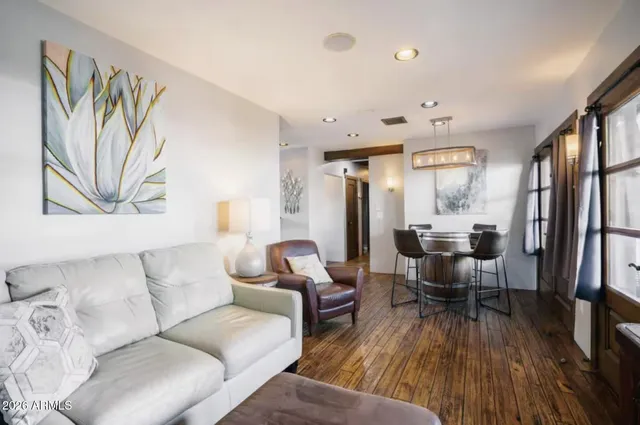 a living room with furniture and wooden floor