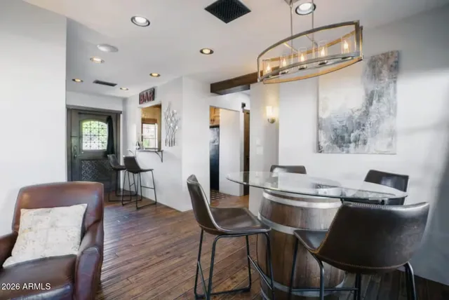 a view of a dining room with furniture a chandelier and wooden floor