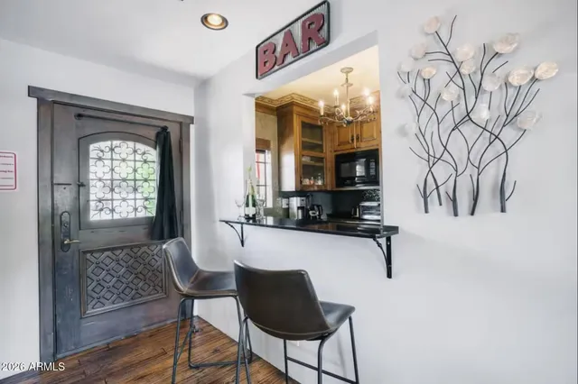 a view of a room with a table and chairs