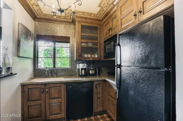 a kitchen with a refrigerator and a sink