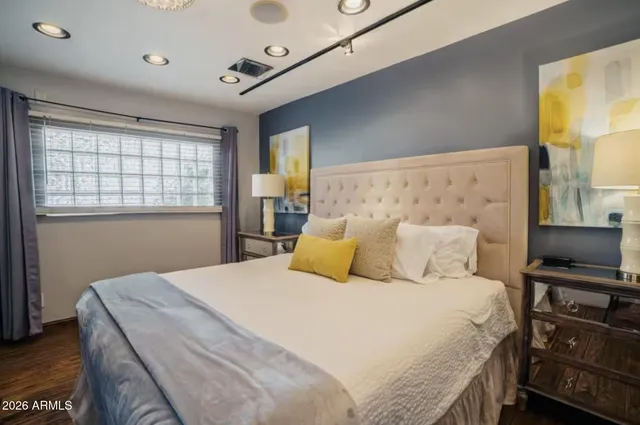 a bedroom with a bed and a tv