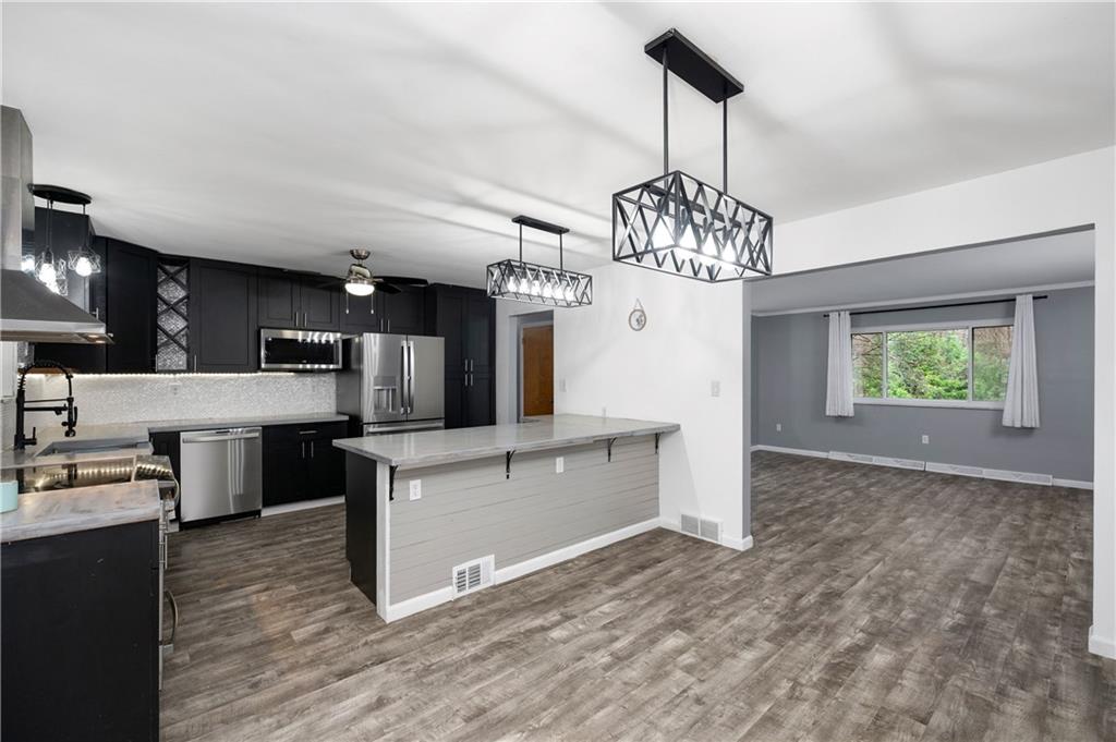 241 La Ray Drive Butler, PA 16001 - Photo 9 of 34 a kitchen with stainless steel appliances granite countertop a stove oven and a refrigerator
