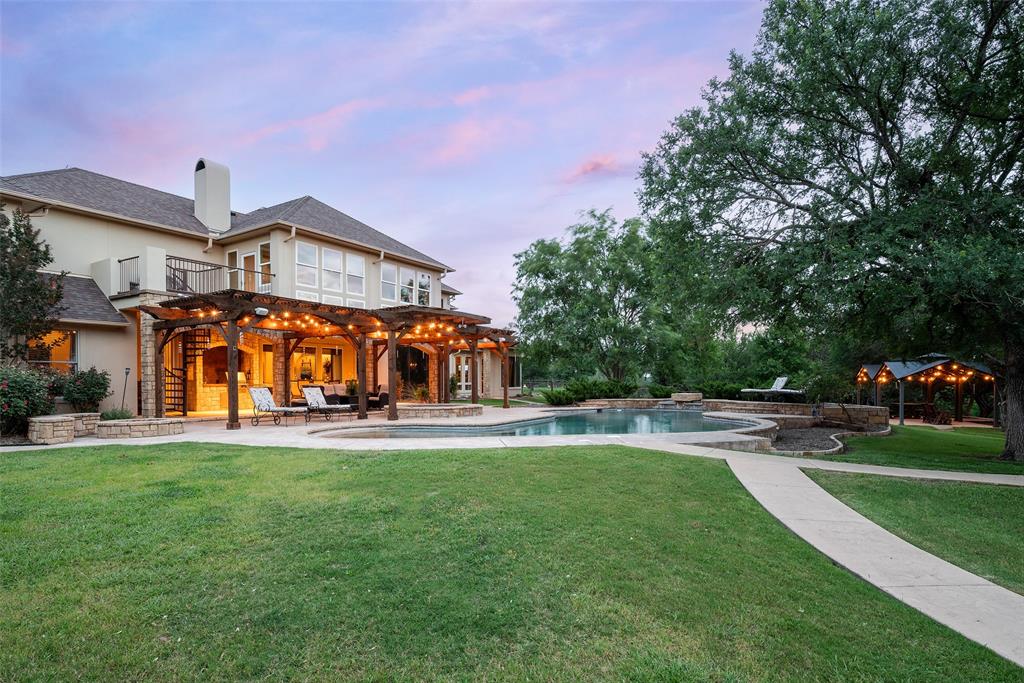 2312 Cactus Rio Lane Weatherford, TX 76087 - Photo 35 of 37 a view of a house with a big yard and large trees