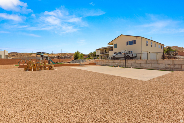 2591 East Washington Dam Road Washington, UT 84780 - Photo 53 of 67 Expansive gravel yard featuring a concrete sports court and a dedicated play area with artificial turf