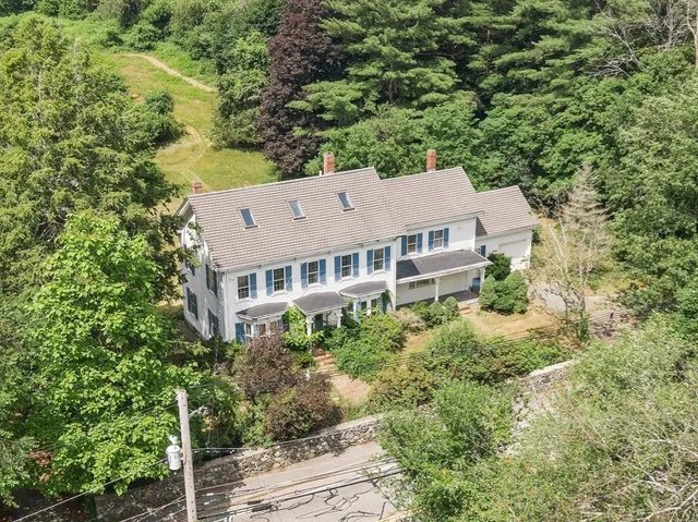 an aerial view of a house with a yard