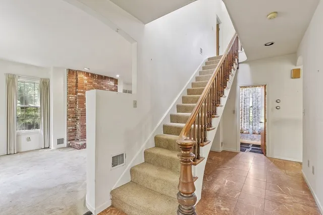 a view of entryway with furniture and wooden floor