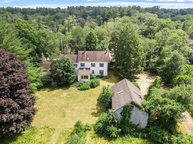 an aerial view of a house with a yard