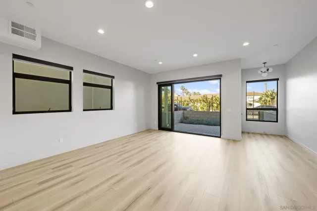 a large kitchen with a stove and large window