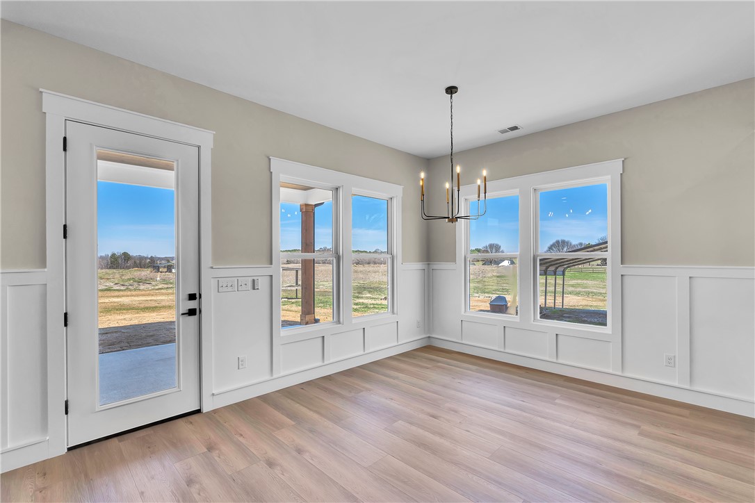 2816 Smith McGee Road Iva, SC 29655 - Photo 11 of 25 Bright windows frame pastoral views, complementing the smooth hardwood flooring and classic wainscoting.