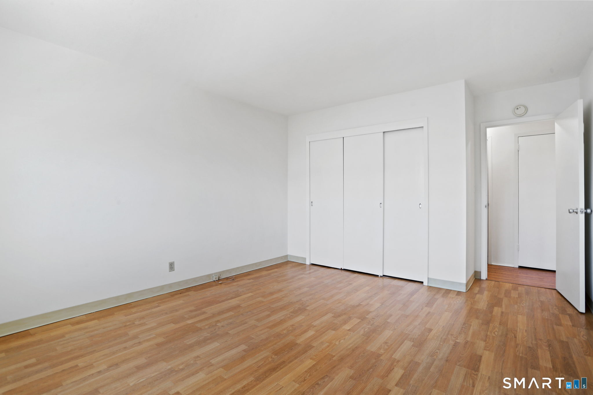 25 Cartright Street, Unit 3K Bridgeport, CT 06604 - Photo 11 of 18 a view of an empty room with wooden floor