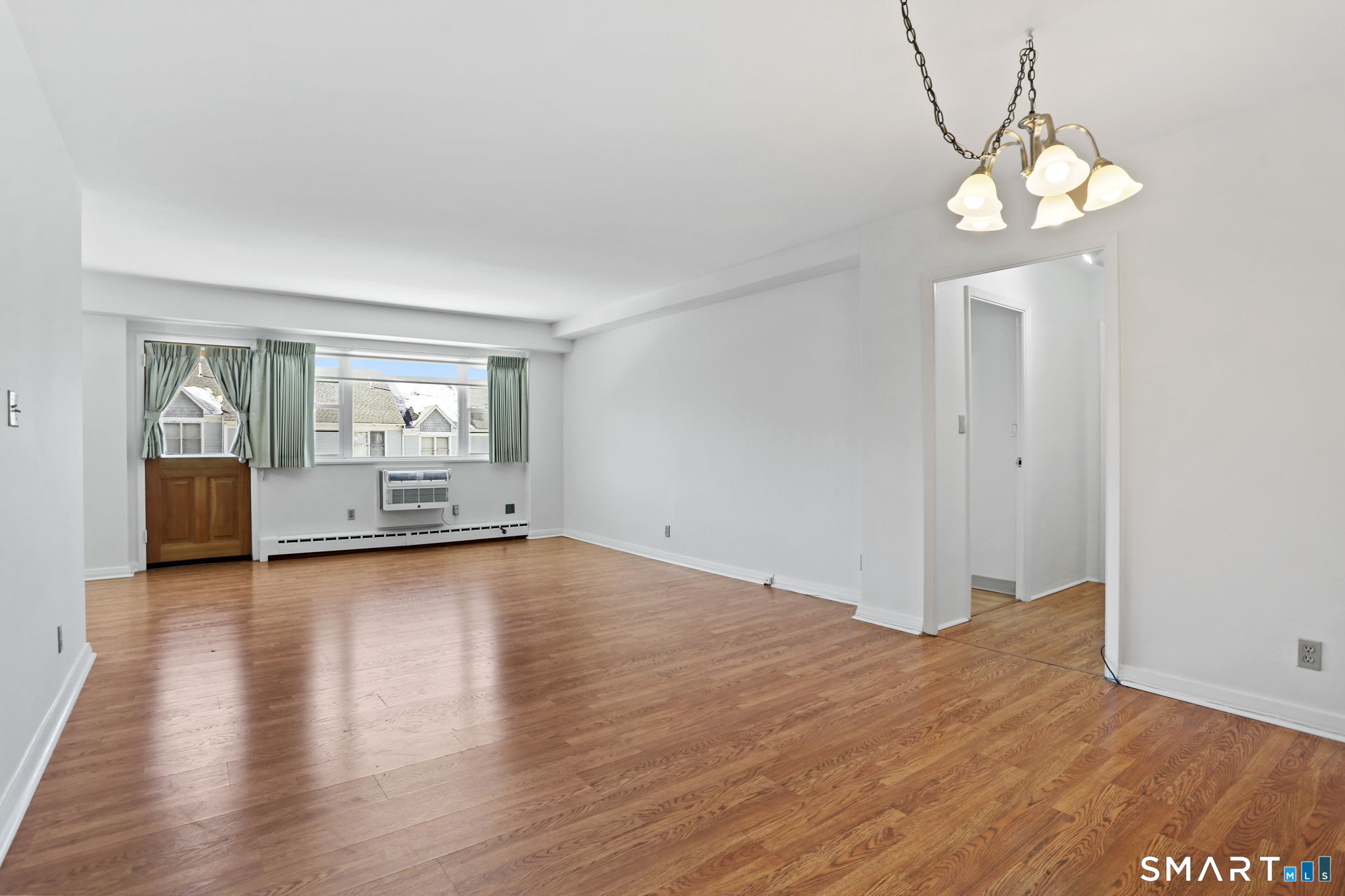 25 Cartright Street, Unit 3K Bridgeport, CT 06604 - Photo 3 of 18 a view of a livingroom with wooden floor and a large window