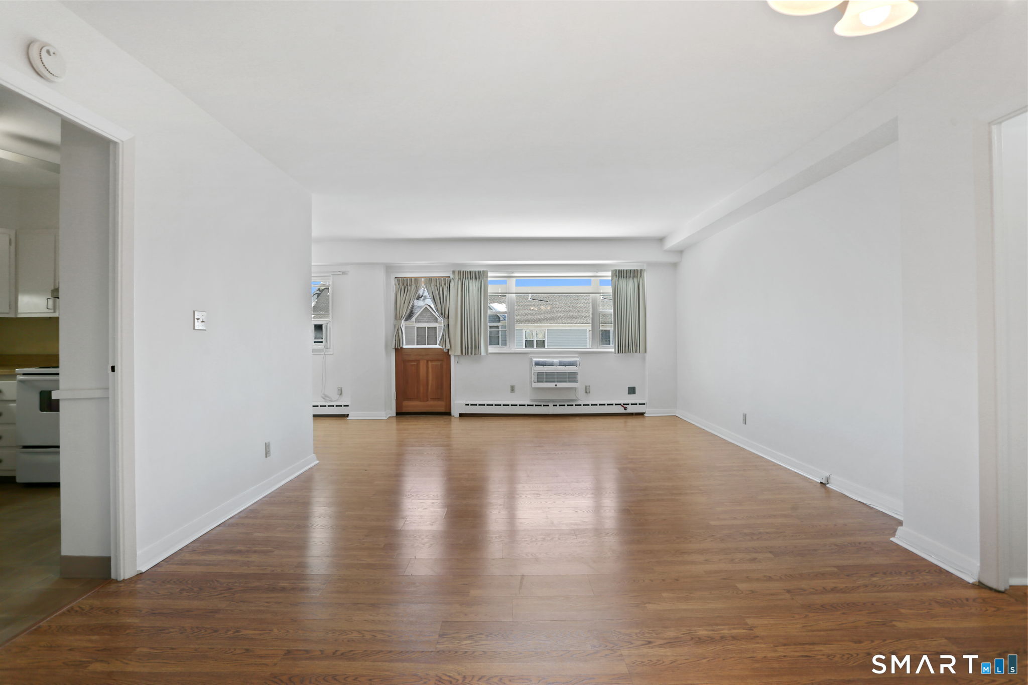 25 Cartright Street, Unit 3K Bridgeport, CT 06604 - Photo 4 of 18 a view of a livingroom with wooden floor and a window