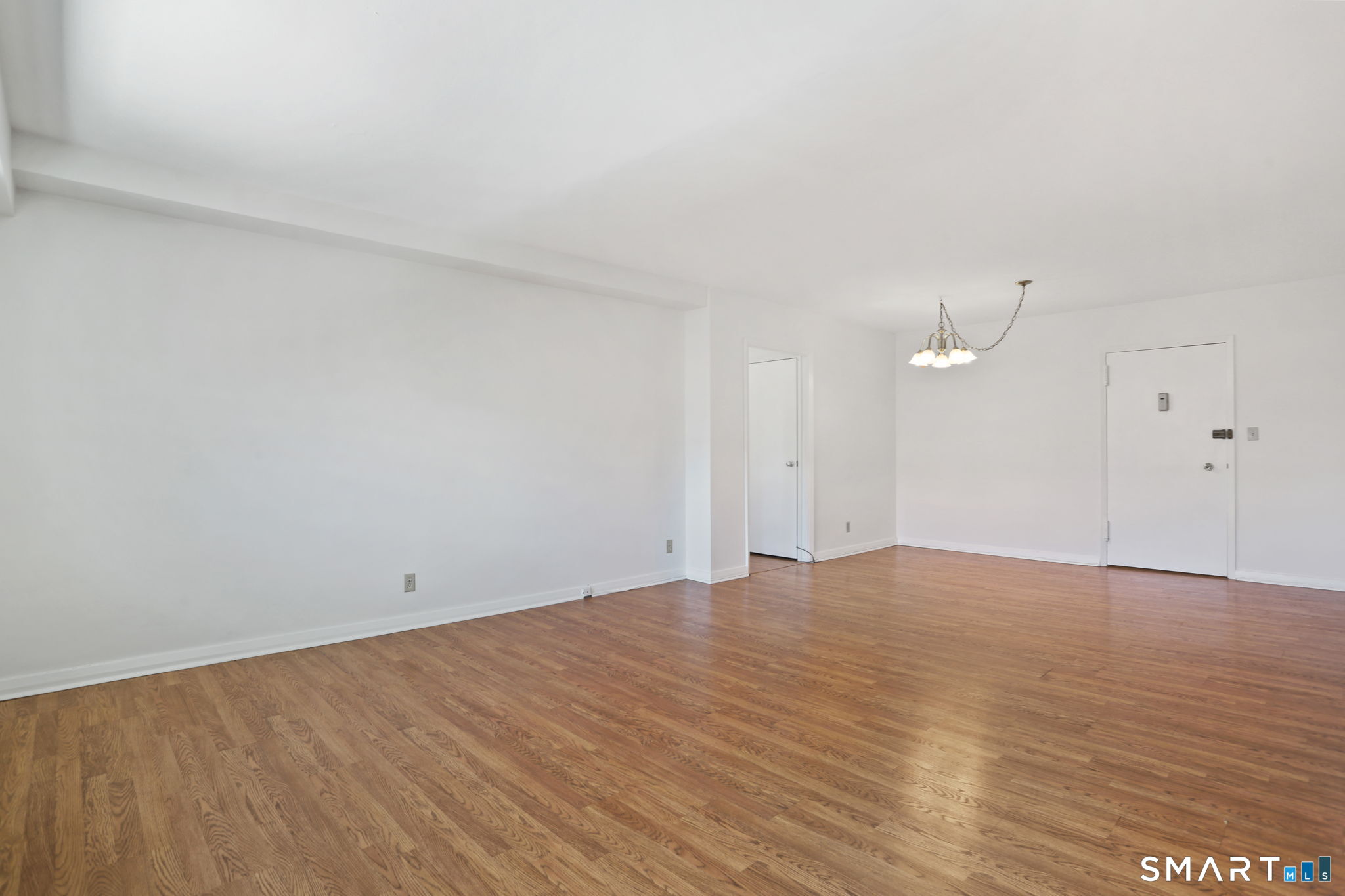 25 Cartright Street, Unit 3K Bridgeport, CT 06604 - Photo 6 of 18 a view of an empty room and wooden floor
