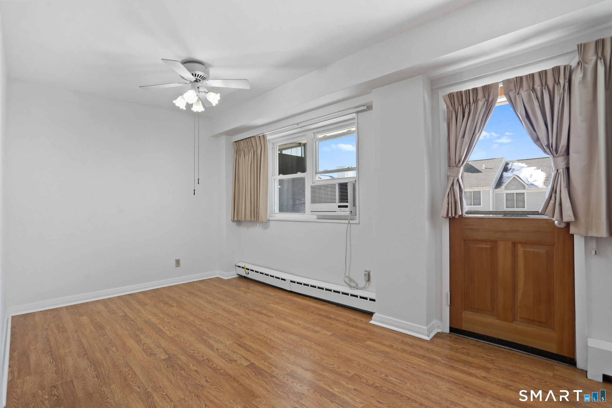 25 Cartright Street, Unit 3K Bridgeport, CT 06604 - Photo 7 of 18 wooden floor in an empty room with a window