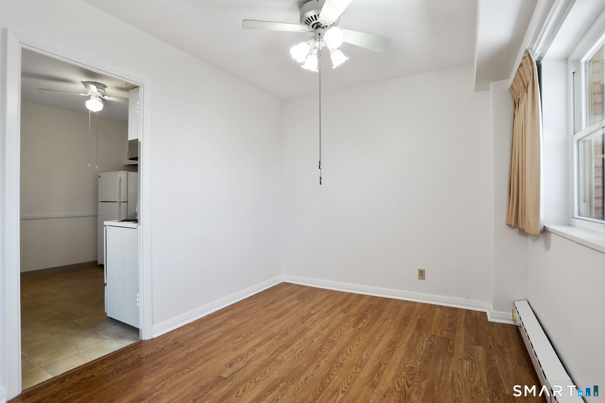 25 Cartright Street, Unit 3K Bridgeport, CT 06604 - Photo 8 of 18 a view of a room with wooden floor and a ceiling fan