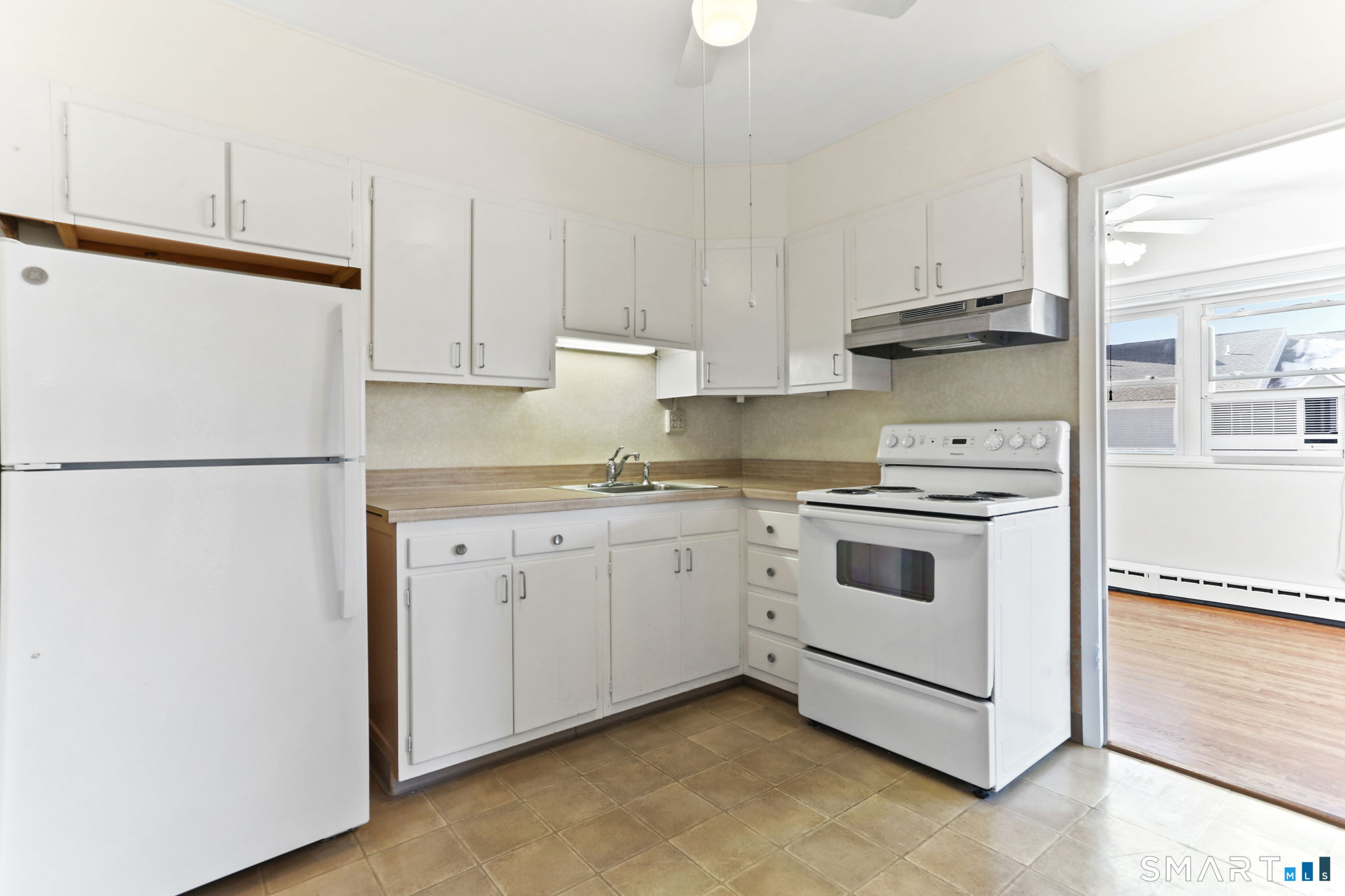 25 Cartright Street, Unit 3K Bridgeport, CT 06604 - Photo 9 of 18 a white kitchen with sink and white stainless steel appliances