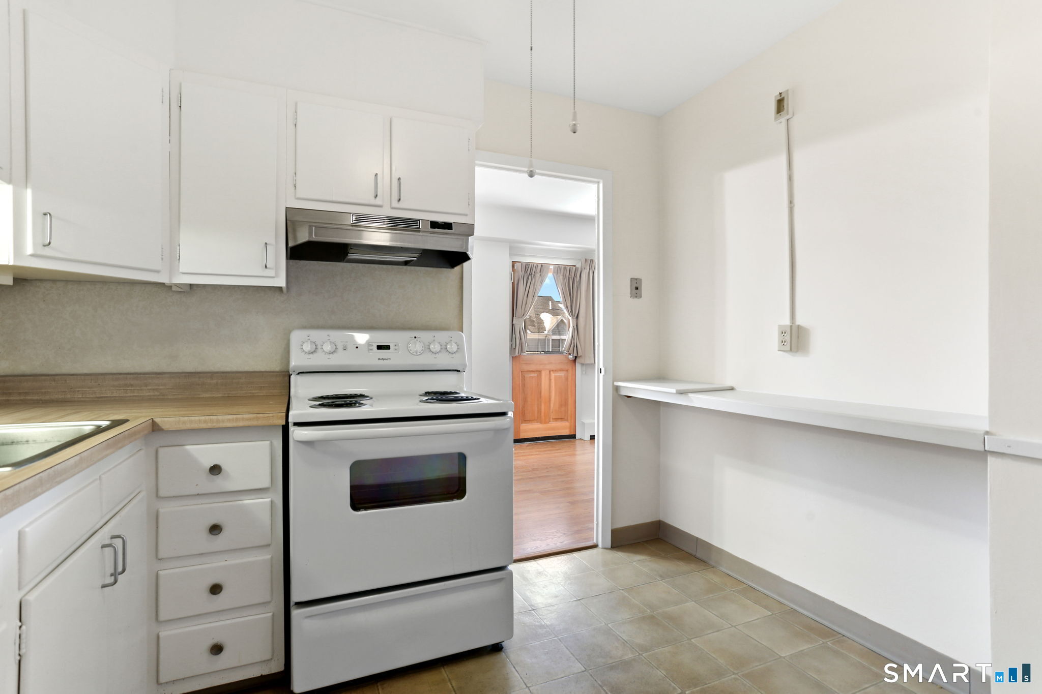 25 Cartright Street, Unit 3K Bridgeport, CT 06604 - Photo 10 of 18 a kitchen with granite countertop white cabinets and white appliances