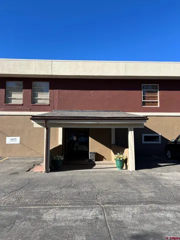 a black car parked in front of a building