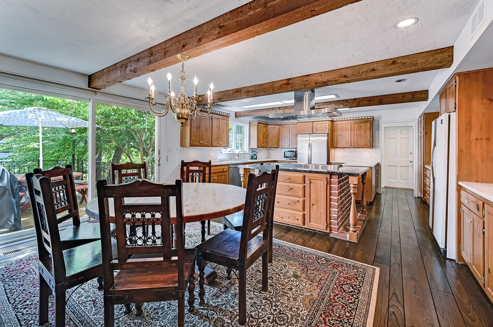 8857 Johnston Road Burr Ridge, IL 60527 - Photo 13 of 47 a dining room with furniture a chandelier and wooden floor