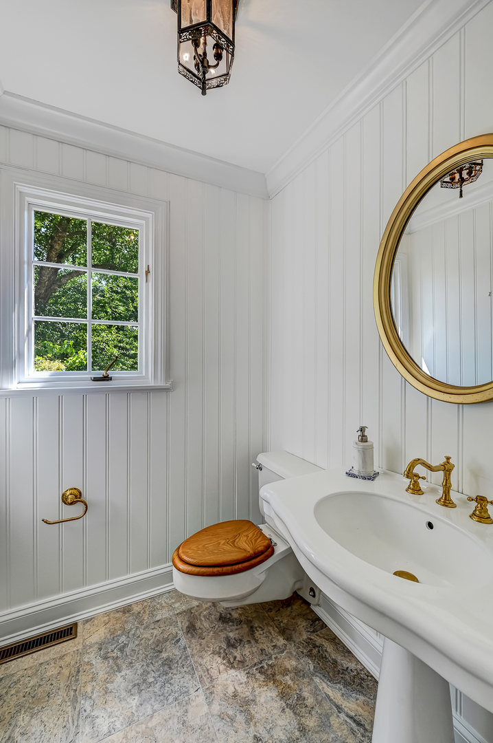 8857 Johnston Road Burr Ridge, IL 60527 - Photo 22 of 47 a bathroom with a sink a toilet and a mirror