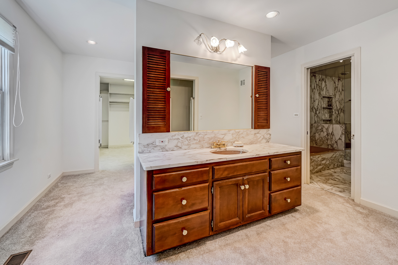 8857 Johnston Road Burr Ridge, IL 60527 - Photo 25 of 47 a spacious bathroom with a granite countertop sink and a mirror