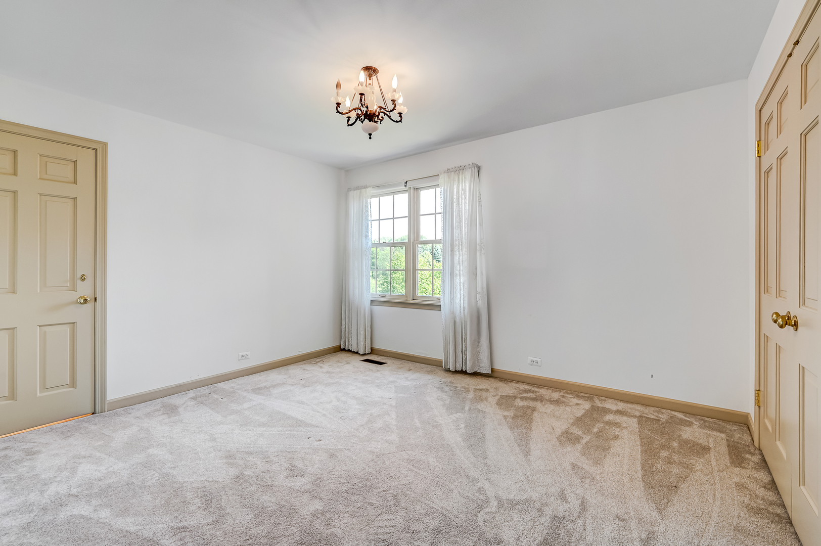 8857 Johnston Road Burr Ridge, IL 60527 - Photo 31 of 47 an empty room with a chandelier fan