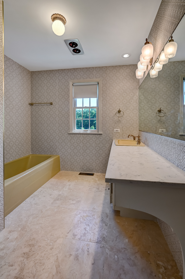 8857 Johnston Road Burr Ridge, IL 60527 - Photo 32 of 47 a bathroom with a sink a tub and a mirror