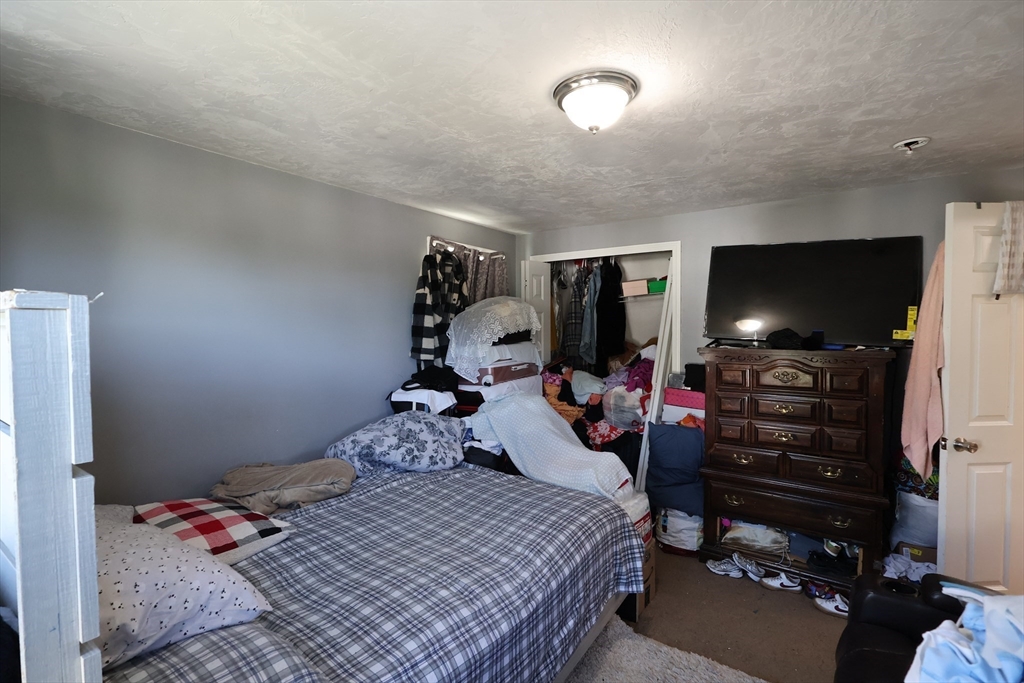 74 Sophia Drive Worcester, MA 01607 - Photo 6 of 15 a bedroom with a bed and a flat screen tv