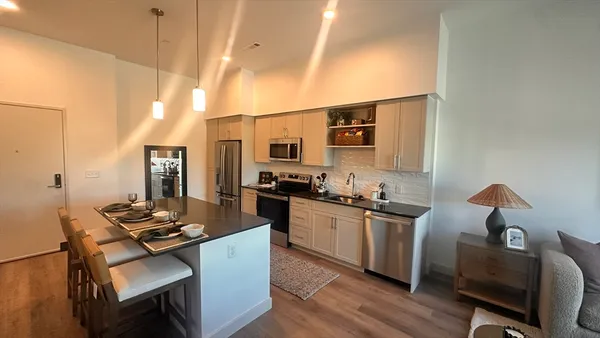 a kitchen with sink stove and chairs