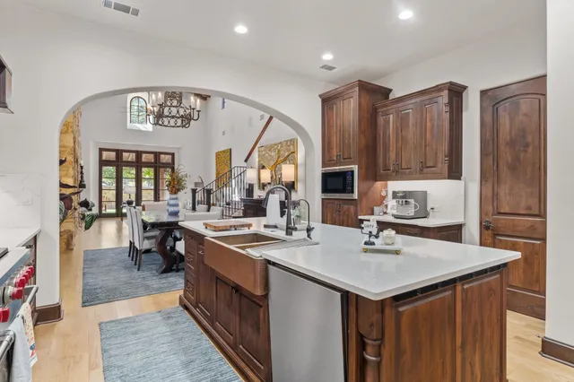 a kitchen with a sink stove and cabinets